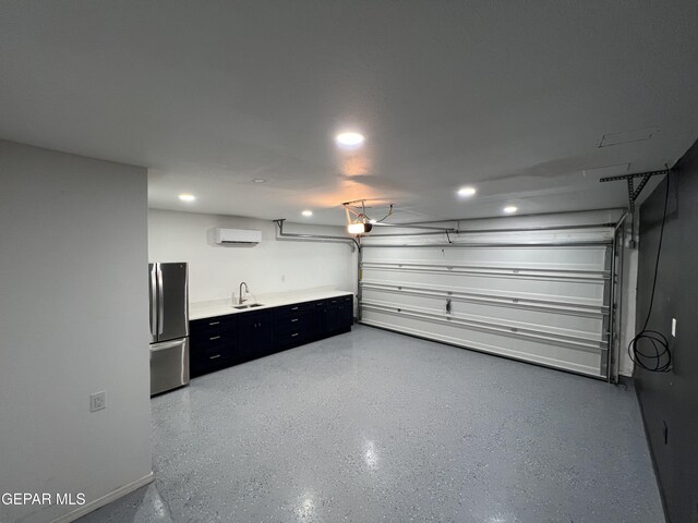 1160 Cielo Mar Dr, Socorro, TX 79927 - garage with freestanding refrigerator, a wall unit AC, a garage door opener, and recessed lighting