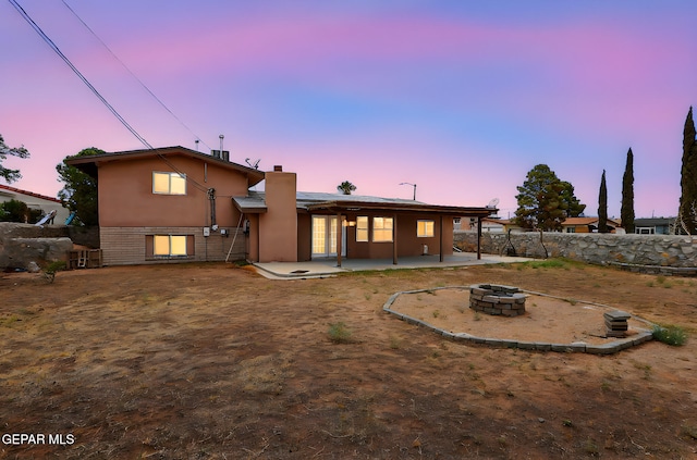 2912 Chaswood St, El Paso, TX 79935 - back of property with a fire pit, a patio, a chimney, stucco siding, and brick siding
