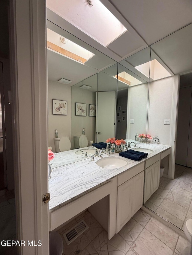 1005 Singing Hills Dr, El Paso, TX 79912 - bathroom with marble finish floors, vanity, and a skylight