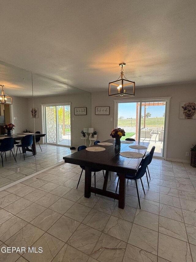 1005 Singing Hills Dr, El Paso, TX 79912 - dining room featuring a chandelier and light marble finish floors