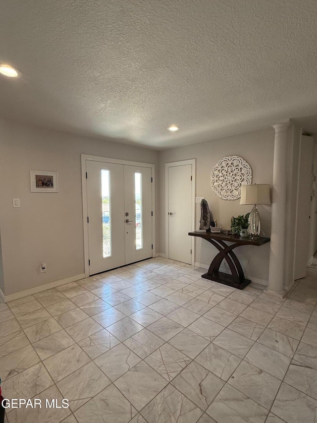 1005 Singing Hills Dr, El Paso, TX 79912 - foyer with light marble finish floors, recessed lighting, and a textured ceiling