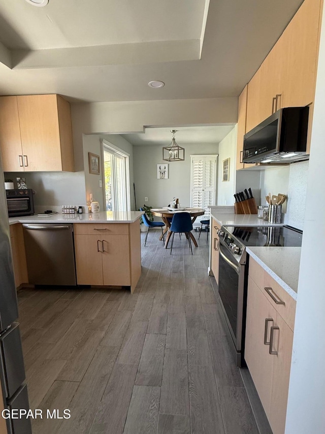 1005 Singing Hills Dr, El Paso, TX 79912 - kitchen with appliances with stainless steel finishes, a peninsula, dark wood-style flooring, light countertops, and light brown cabinets