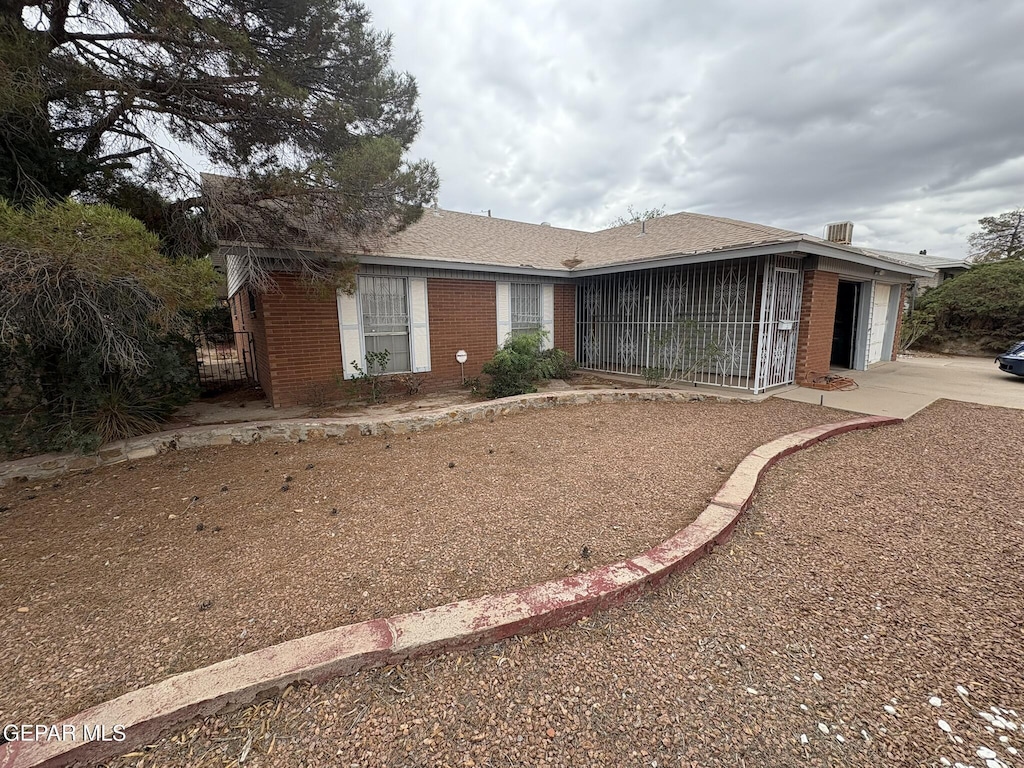 10304 Woodruff Ct, El Paso, TX 79925 - ranch-style house with an attached garage, brick siding, and driveway