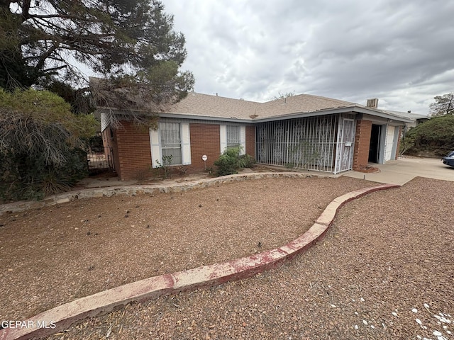 10304 Woodruff Ct, El Paso, TX 79925 - ranch-style house with an attached garage, brick siding, and driveway