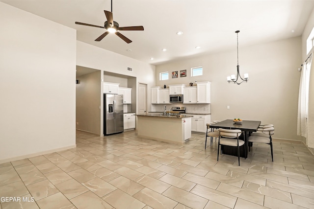 14512 Dominic Azcarate Dr, El Paso, TX 79938 - kitchen featuring stainless steel appliances, a chandelier, ceiling fan, a center island with sink, and hanging light fixtures