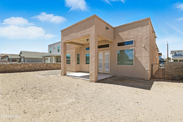14512 Dominic Azcarate Dr, El Paso, TX 79938 - rear view of house with french doors, a patio area, stucco siding, and a gate