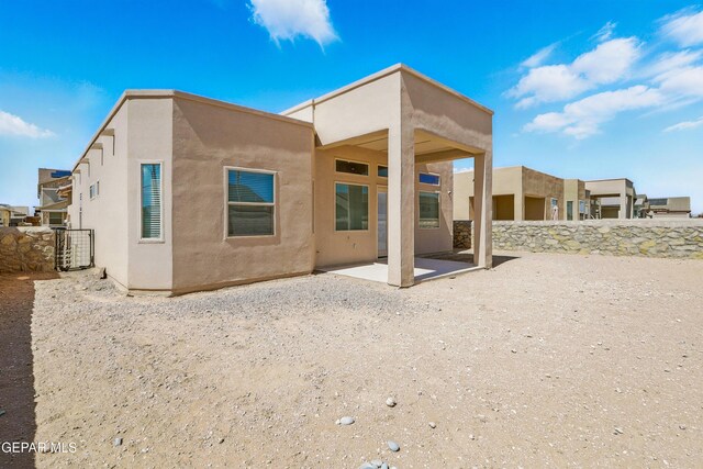 14512 Dominic Azcarate Dr, El Paso, TX 79938 - back of house with stucco siding and a patio area