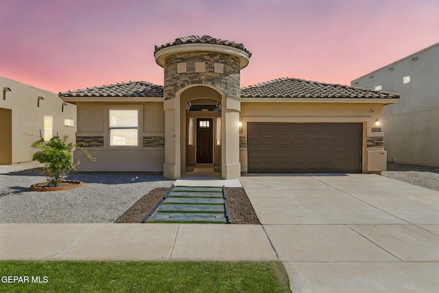 14512 Dominic Azcarate Dr, El Paso, TX 79938 - mediterranean / spanish-style home featuring a tile roof, an attached garage, stucco siding, driveway, and stone siding