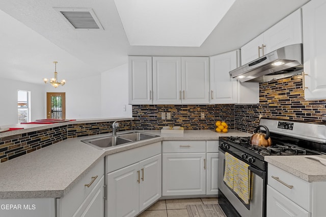 12290 Tierra Bella Dr, El Paso, TX 79938 - kitchen with stainless steel gas range oven, under cabinet range hood, a peninsula, and backsplash