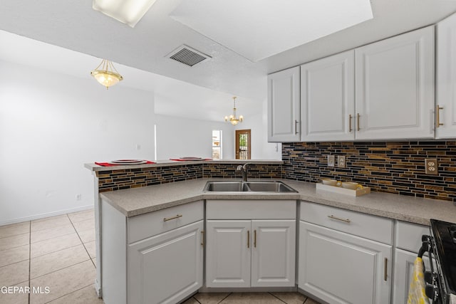 12290 Tierra Bella Dr, El Paso, TX 79938 - kitchen featuring tasteful backsplash, white cabinetry, a peninsula, light tile patterned floors, and black gas range