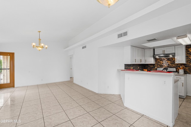12290 Tierra Bella Dr, El Paso, TX 79938 - kitchen featuring under cabinet range hood, a chandelier, tasteful backsplash, light tile patterned floors, and white cabinets