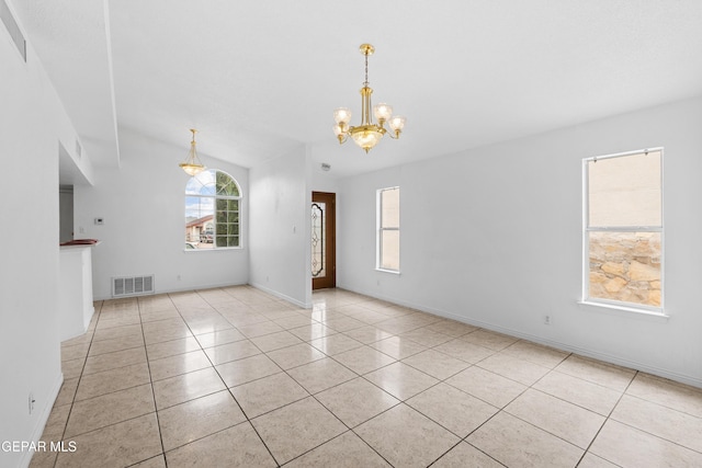 12290 Tierra Bella Dr, El Paso, TX 79938 - unfurnished living room featuring healthy amount of natural light, a chandelier, and light tile patterned flooring