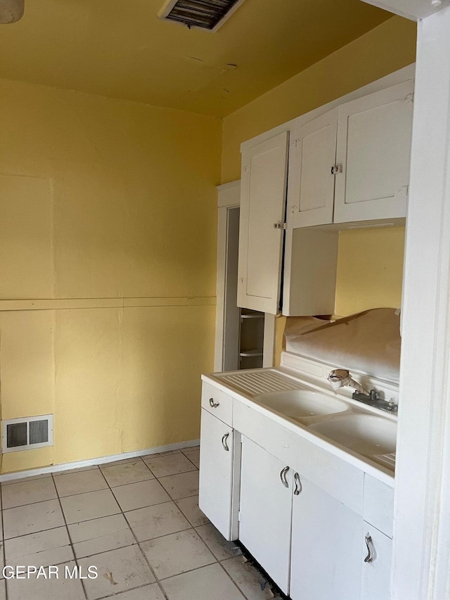 1118 N Laurel St, El Paso, TX 79902 - kitchen with white cabinetry, light tile patterned floors, and light countertops