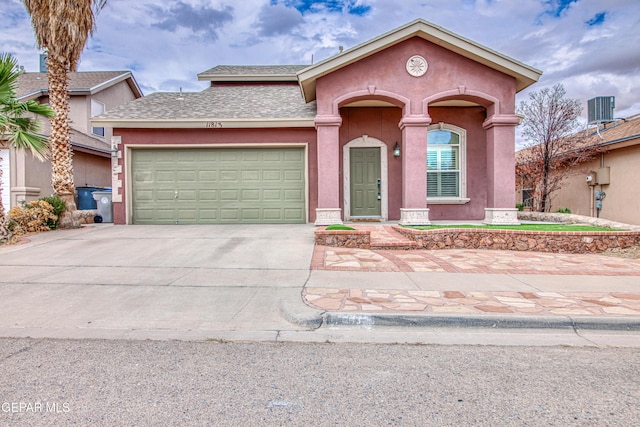 11813 Deer Grass Cir, El Paso, TX 79936 - view of front of house with driveway, an attached garage, stucco siding, and a shingled roof