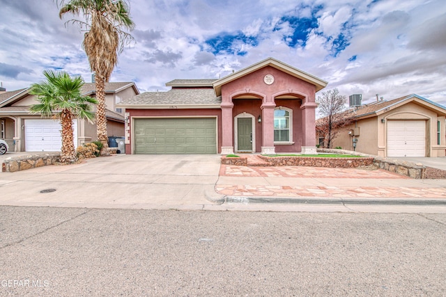 11813 Deer Grass Cir, El Paso, TX 79936 - mediterranean / spanish house with stucco siding, concrete driveway, a garage, and a shingled roof