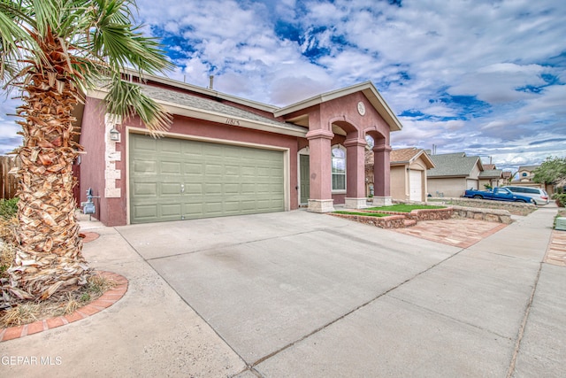 11813 Deer Grass Cir, El Paso, TX 79936 - view of front of house featuring concrete driveway, an attached garage, and stucco siding