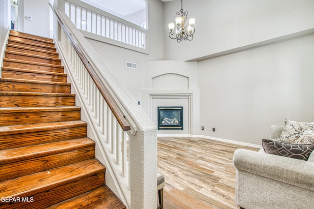 11813 Deer Grass Cir, El Paso, TX 79936 - stairs featuring wood finished floors, a chandelier, and a high ceiling