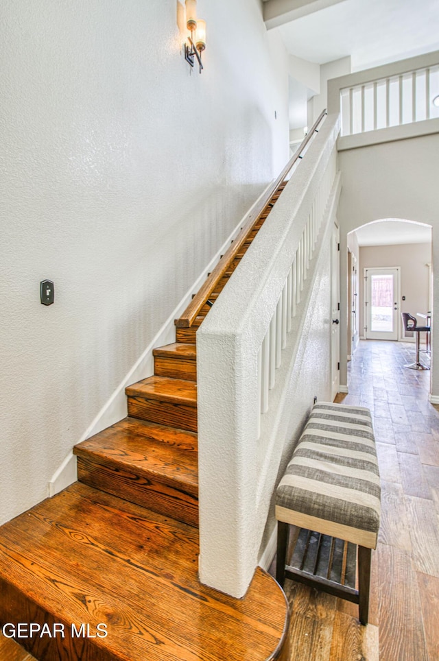11813 Deer Grass Cir, El Paso, TX 79936 - stairway with arched walkways and wood finished floors