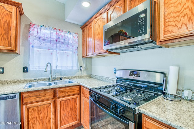 11813 Deer Grass Cir, El Paso, TX 79936 - kitchen featuring stainless steel appliances, light countertops, and brown cabinetry