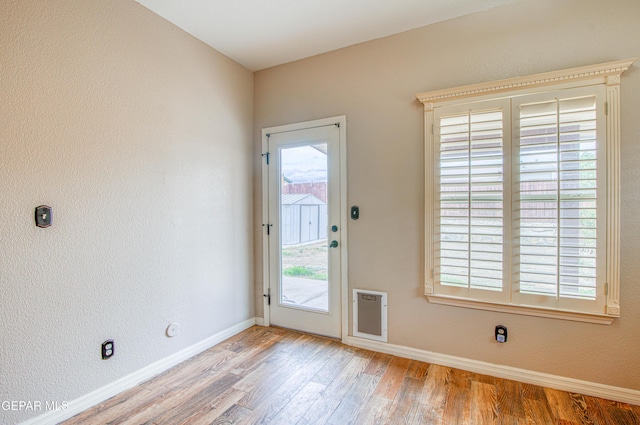 11813 Deer Grass Cir, El Paso, TX 79936 - doorway to outside featuring light wood finished floors and baseboards
