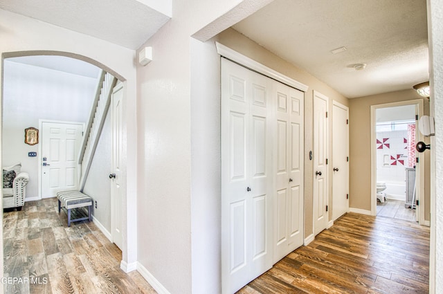 11813 Deer Grass Cir, El Paso, TX 79936 - corridor with arched walkways, wood finished floors, and a textured ceiling