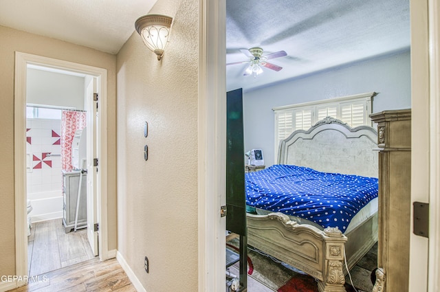 11813 Deer Grass Cir, El Paso, TX 79936 - bedroom featuring a textured wall, wood finished floors, ensuite bathroom, and a ceiling fan