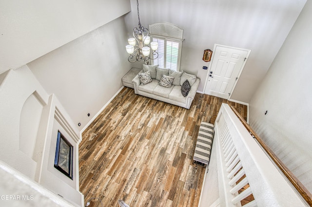 11813 Deer Grass Cir, El Paso, TX 79936 - living room with wood finished floors, a chandelier, and a towering ceiling