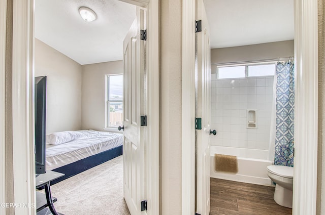 11813 Deer Grass Cir, El Paso, TX 79936 - ensuite bathroom with shower / bath combo with shower curtain and wood finished floors