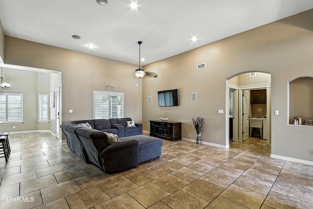 14552 Long Shadow Ave, El Paso, TX 79938 - tiled living room featuring arched walkways, a high ceiling, and recessed lighting