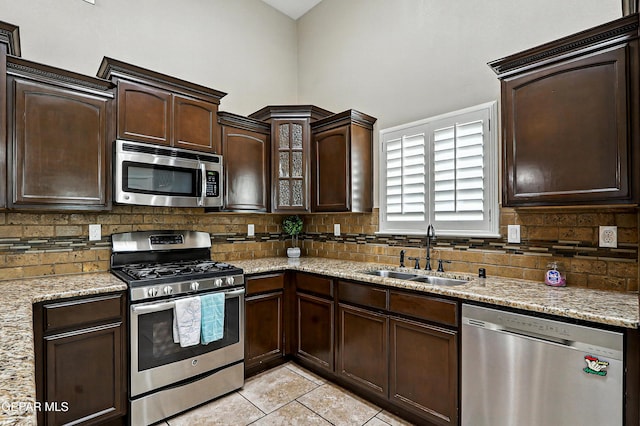 14552 Long Shadow Ave, El Paso, TX 79938 - kitchen with stainless steel appliances, tasteful backsplash, dark brown cabinetry, and light tile patterned floors