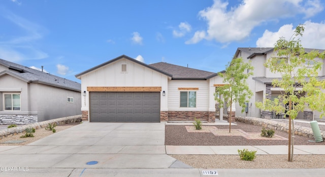 11157 Blazing Star Pl, El Paso, TX 79934 - view of front of house featuring stone siding, driveway, a garage, and board and batten siding
