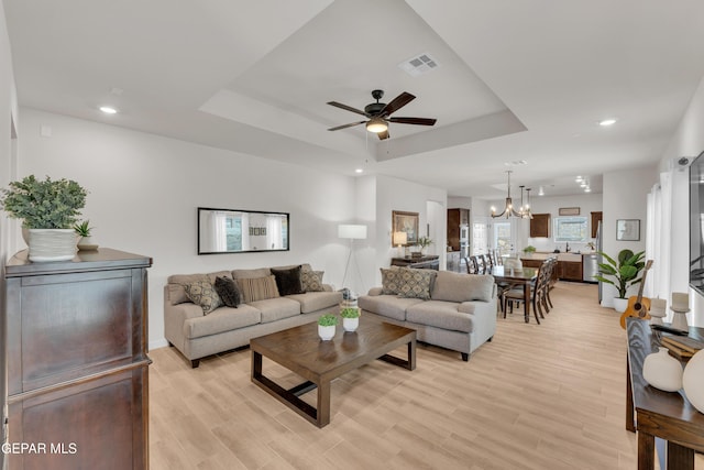 11157 Blazing Star Pl, El Paso, TX 79934 - living room featuring a ceiling fan, a raised ceiling, a chandelier, light wood-type flooring, and recessed lighting