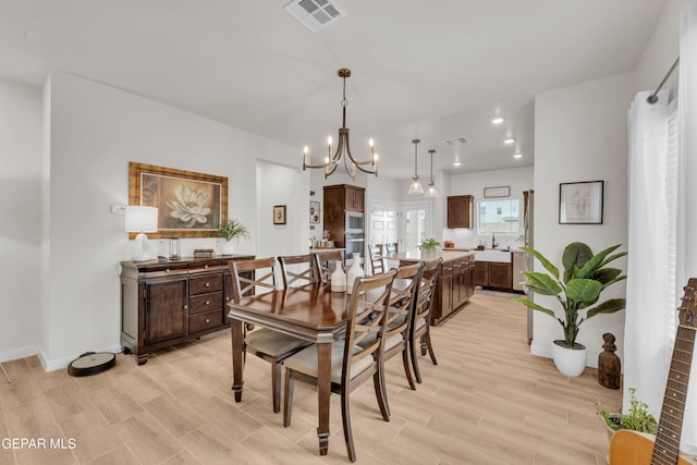 11157 Blazing Star Pl, El Paso, TX 79934 - dining room featuring light wood finished floors and a chandelier