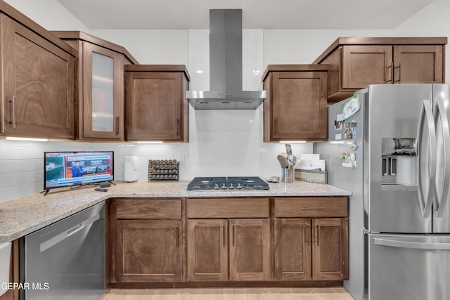 11157 Blazing Star Pl, El Paso, TX 79934 - kitchen with appliances with stainless steel finishes, wall chimney exhaust hood, decorative backsplash, and light stone countertops