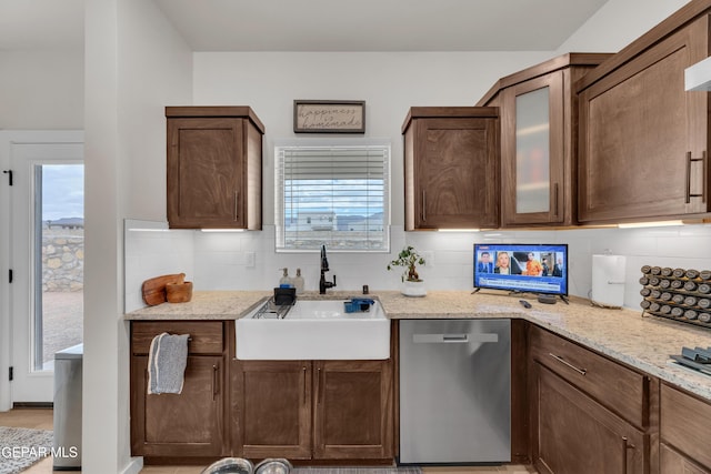 11157 Blazing Star Pl, El Paso, TX 79934 - kitchen with dishwasher, decorative backsplash, light stone countertops, and glass insert cabinets