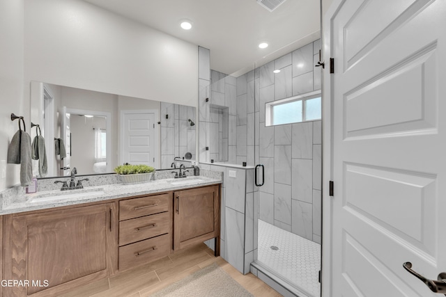 11157 Blazing Star Pl, El Paso, TX 79934 - bathroom with a stall shower, double vanity, recessed lighting, and wood finished floors