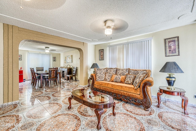 11581 Valle Verde Rd, Socorro, TX 79927 - living area with arched walkways, a textured ceiling, and ceiling fan
