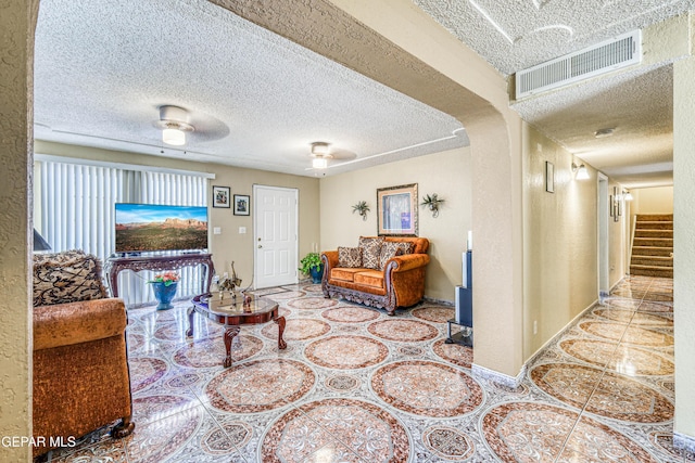 11581 Valle Verde Rd, Socorro, TX 79927 - tiled living room featuring a textured ceiling and stairway