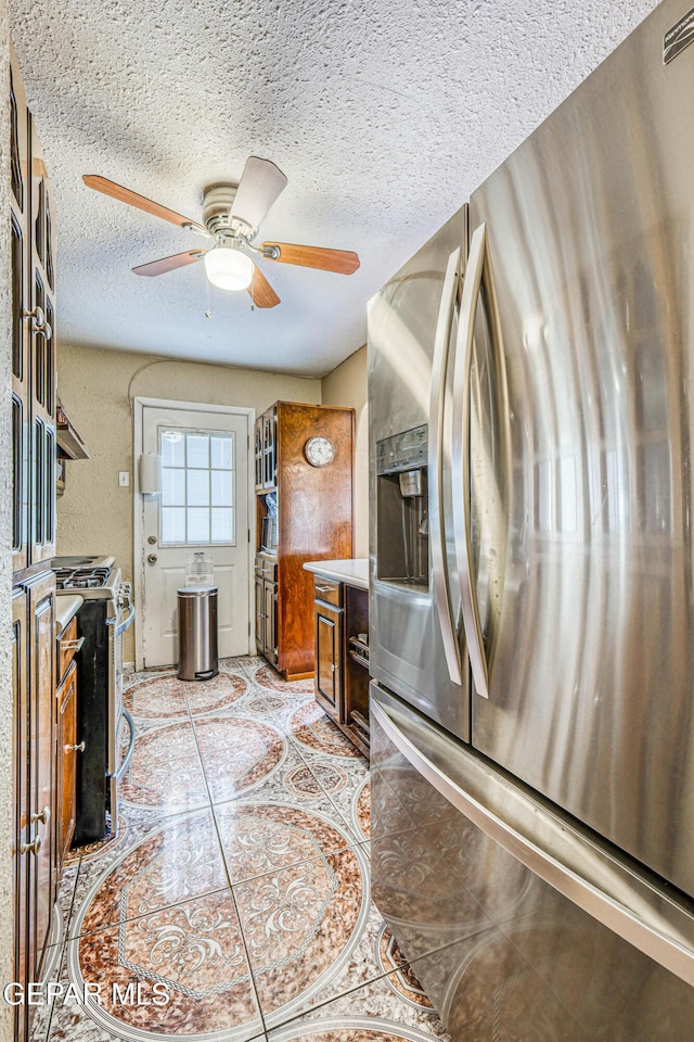 11581 Valle Verde Rd, Socorro, TX 79927 - kitchen with stainless steel appliances, ceiling fan, and a textured ceiling