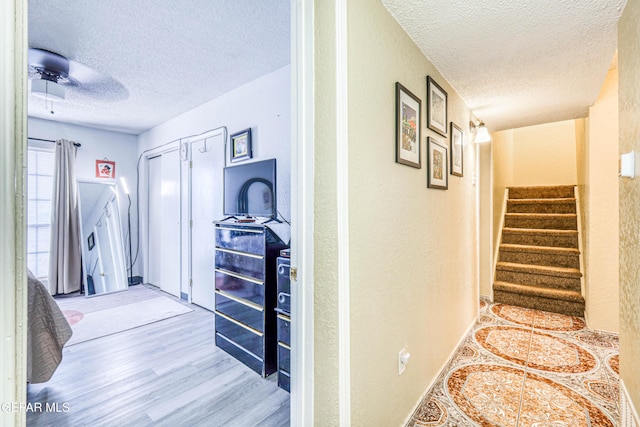 11581 Valle Verde Rd, Socorro, TX 79927 - corridor featuring a textured ceiling, wood finished floors, and stairs