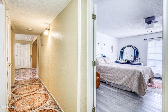 11581 Valle Verde Rd, Socorro, TX 79927 - hallway with a textured ceiling, a textured wall, and wood finished floors