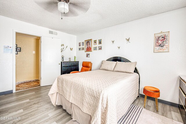 11581 Valle Verde Rd, Socorro, TX 79927 - bedroom featuring wood finished floors, a textured ceiling, and ceiling fan