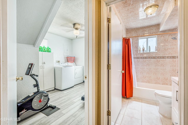 11581 Valle Verde Rd, Socorro, TX 79927 - washroom with washing machine and clothes dryer, a textured wall, a textured ceiling, ceiling fan, and light wood-type flooring