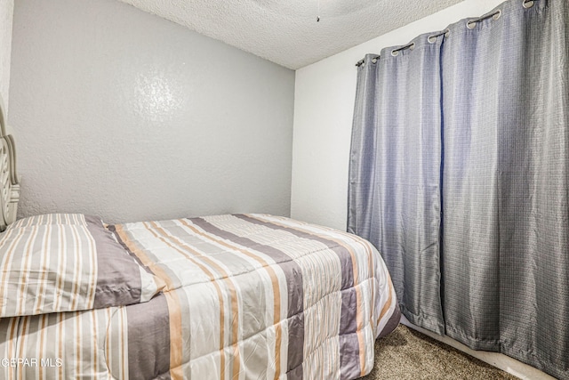 11581 Valle Verde Rd, Socorro, TX 79927 - carpeted bedroom featuring a textured ceiling and a textured wall