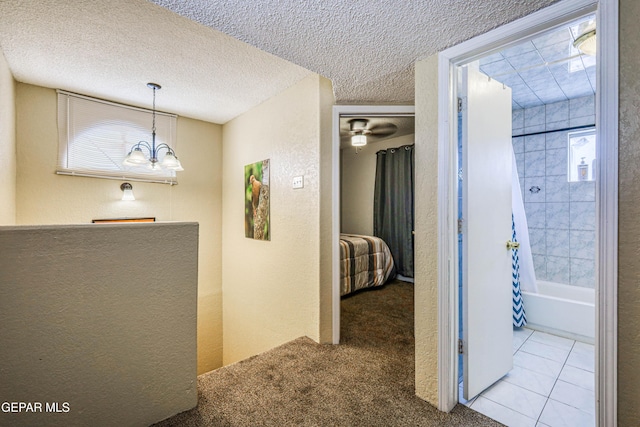 11581 Valle Verde Rd, Socorro, TX 79927 - corridor featuring a textured wall, carpet, and a chandelier