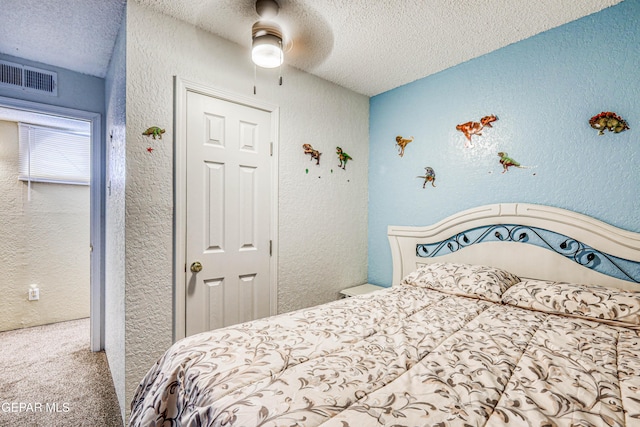 11581 Valle Verde Rd, Socorro, TX 79927 - bedroom with a textured ceiling, a textured wall, carpet, and ceiling fan