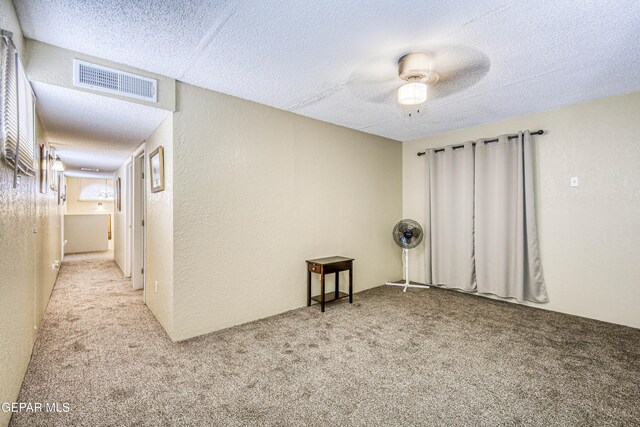 11581 Valle Verde Rd, Socorro, TX 79927 - carpeted empty room with a textured ceiling, ceiling fan, and a textured wall