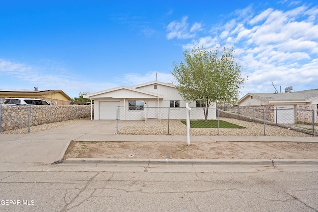 205 Caribe Cir, El Paso, TX 79927 - view of front of property with driveway, a fenced front yard, and an attached garage