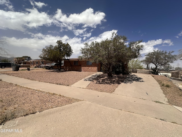 5013 Winthrop Dr, El Paso, TX 79924 - view of front facade featuring concrete driveway, a garage, and brick siding