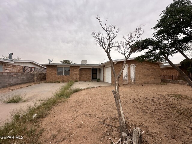 10436 Orpheus Dr, El Paso, TX 79924 - back of property with an attached garage, brick siding, and concrete driveway